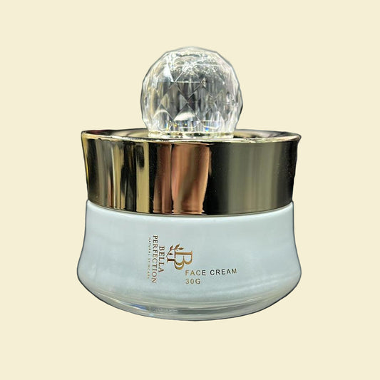 White face cream jar with gold cap on a black surface