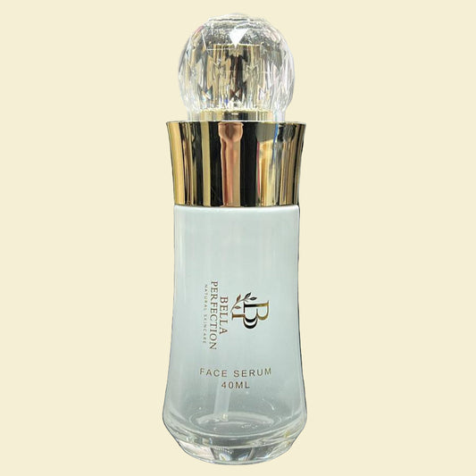 Clear bottle with gold cap on a dark surface