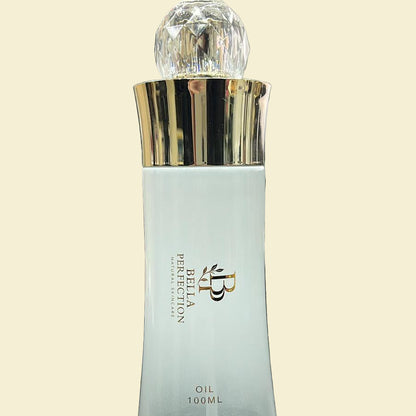Bella Perfection oil bottle with gold cap on a desk