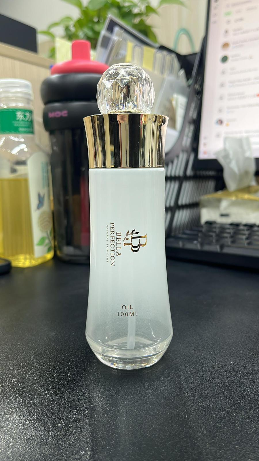 Skincare bottle with gold cap on a desk